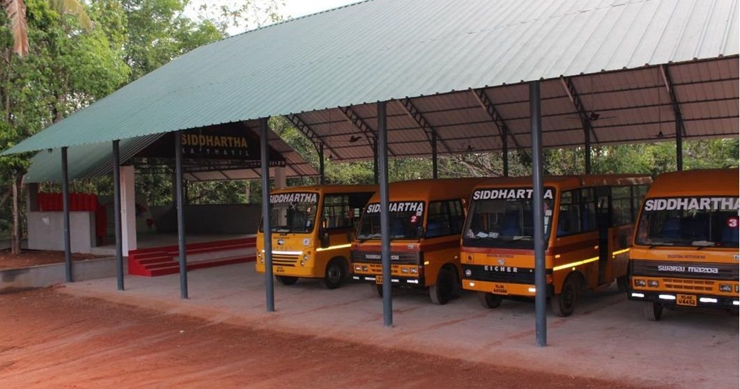 The Siddhartha school bus fleet parked in the campus shed
